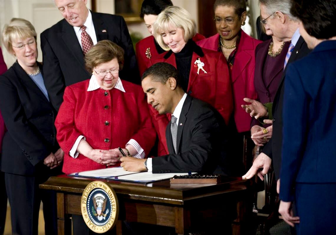 President Obama signs the Lilly Ledbetter Fair Pay Act, with Alabama's Lilly Ledbetter at his side
