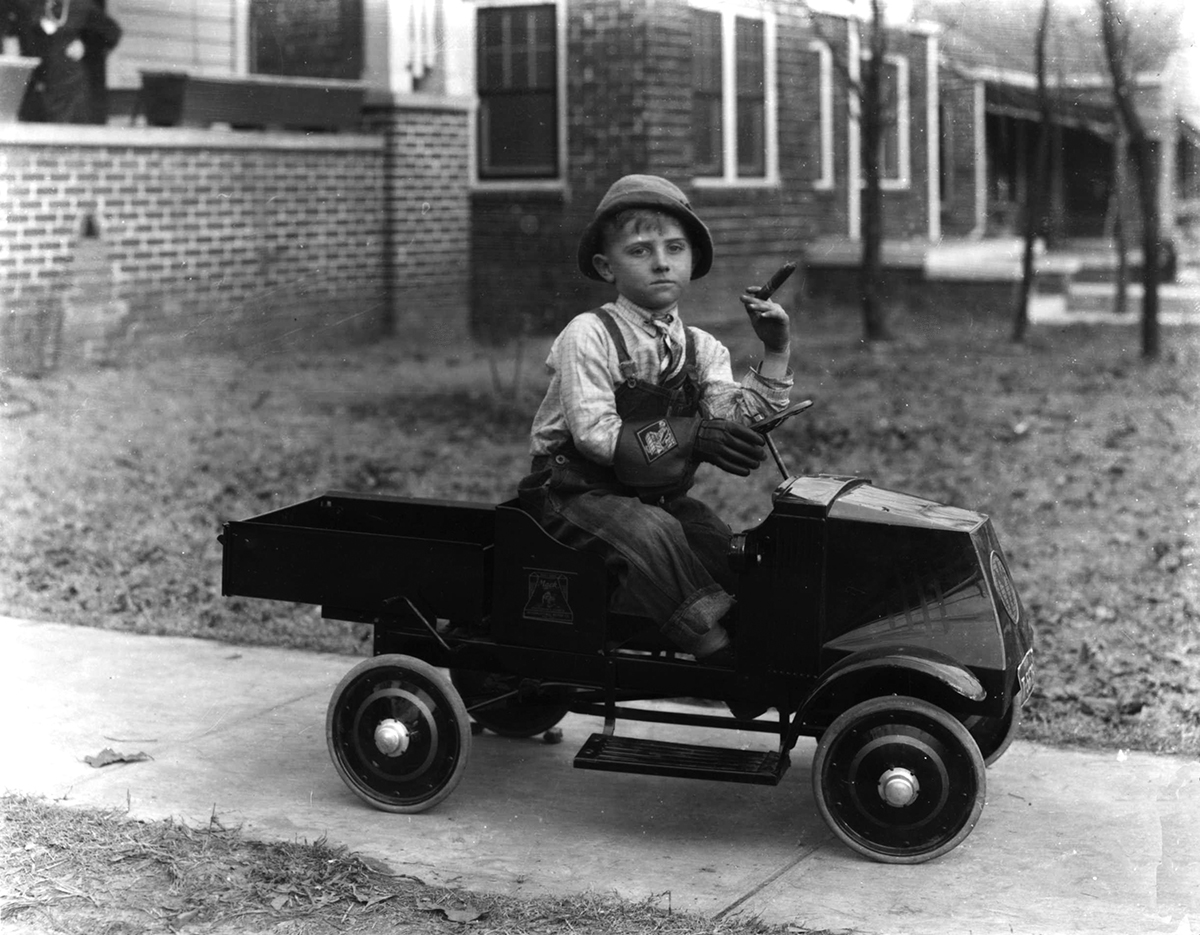 Young boy with a car and cigar, Birmingham, Alabama, 1935