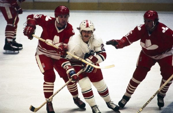 Three hockey players photographed during a game