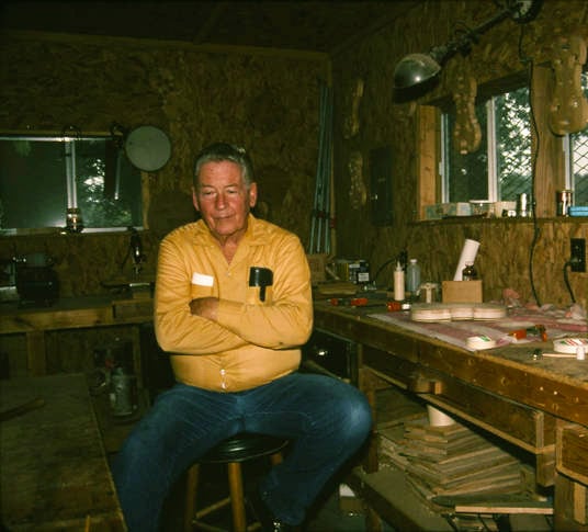 Gene Ivey seated at his workshop.