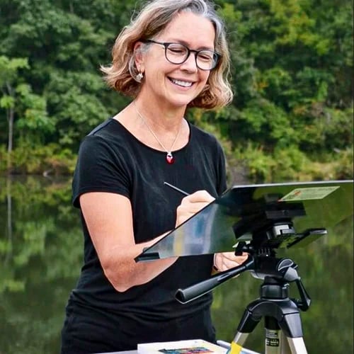 Cindy Wheeler pictured drawing at an easel outdoors
